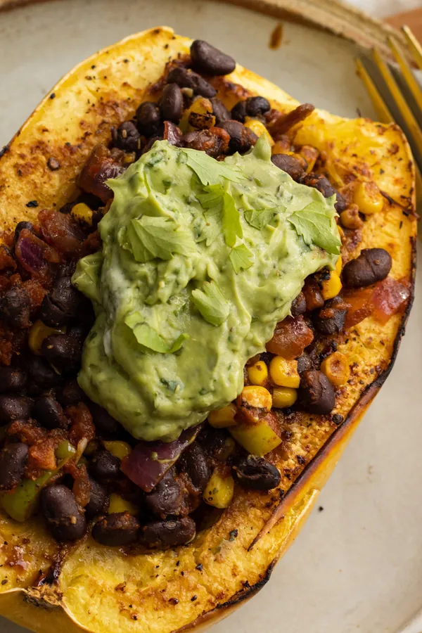 Vegan Black Bean and Corn Stuffed Spaghetti Squash with Avocado Crema