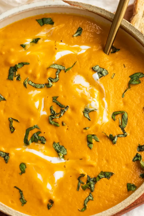 vegan creamy carrot tomato soup with cashews and basil
